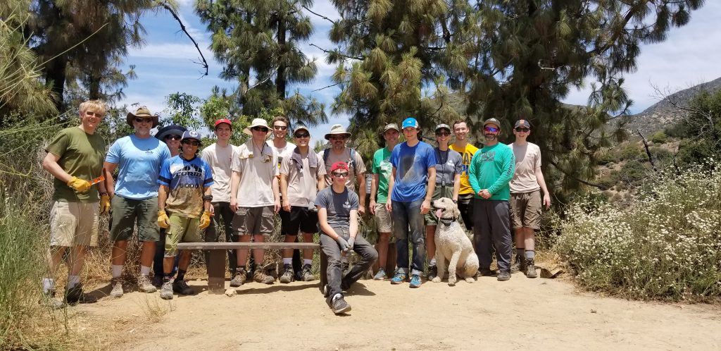 Nick Sercel (seated) and crew admire the first bench seat installed brown mountain saddle