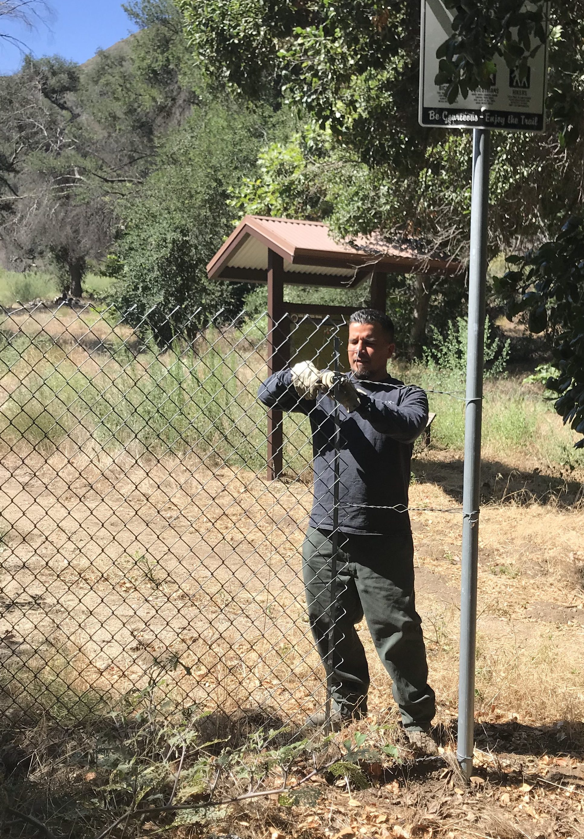 LA County Parks Staff remove the fence at the trailhead, opening the trail